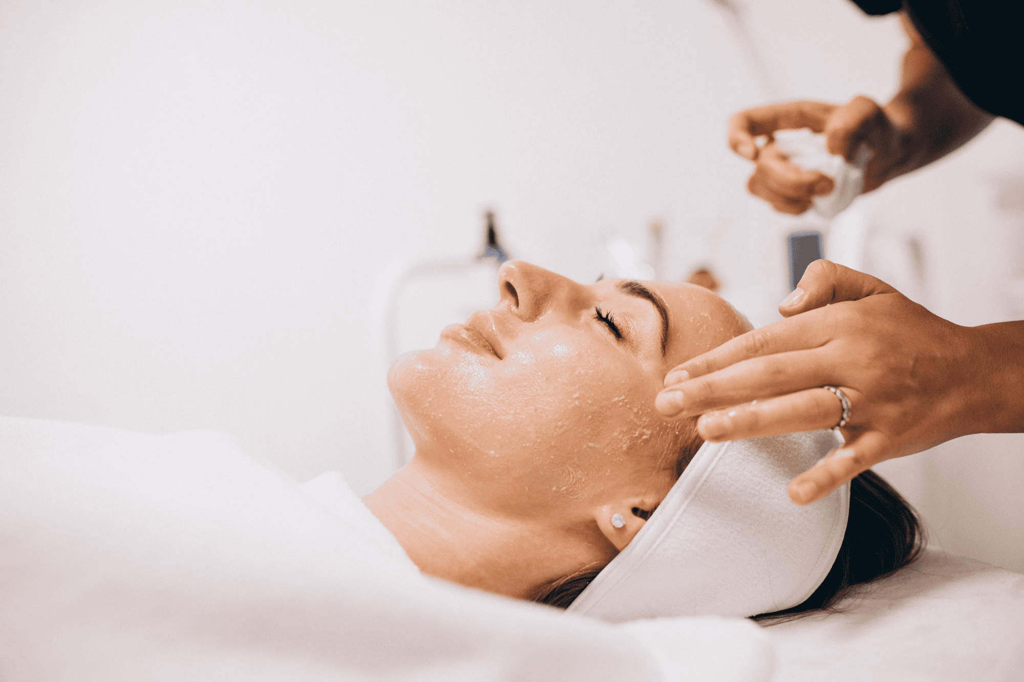 cosmetologist cleaning face woman beauty salon