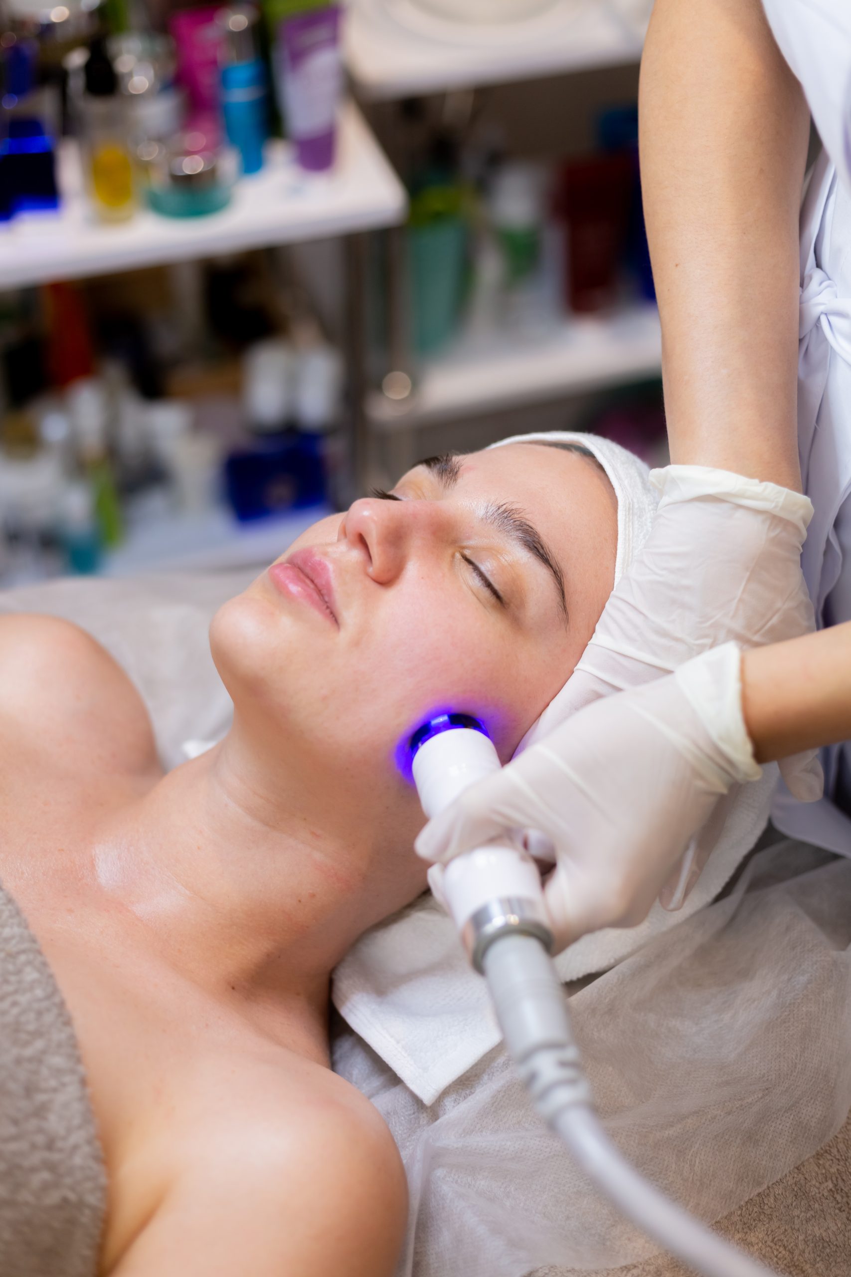 young beautiful girl lies beautician s table receives procedures scaled