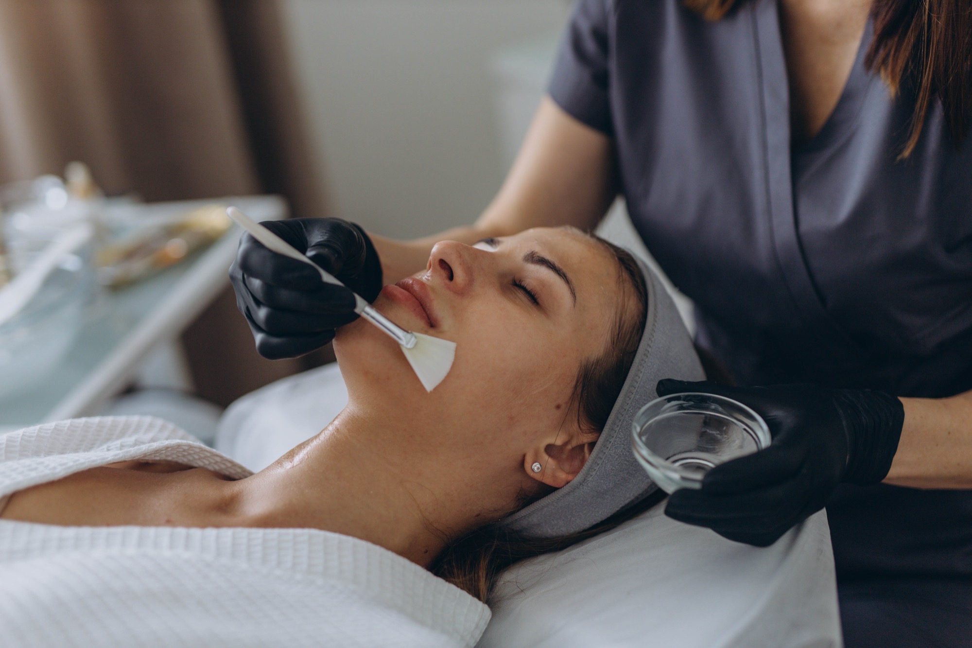 Acne Extreme 1 Practitioner applying a facial peel to a client in clinic
