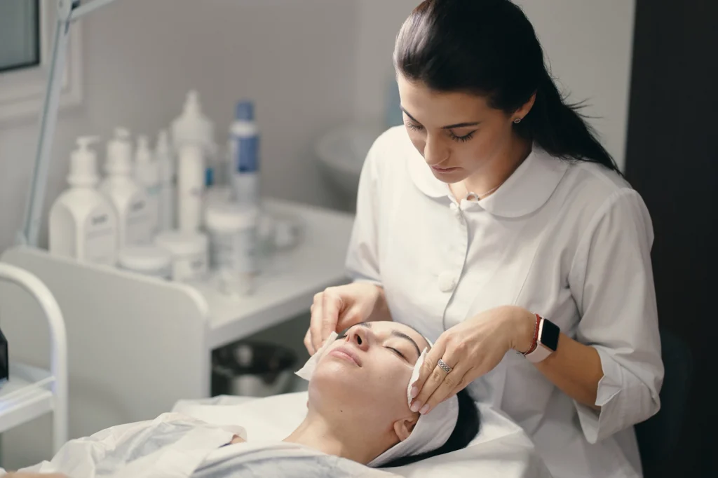 Practitioner performing a facial skincare treatment on a client